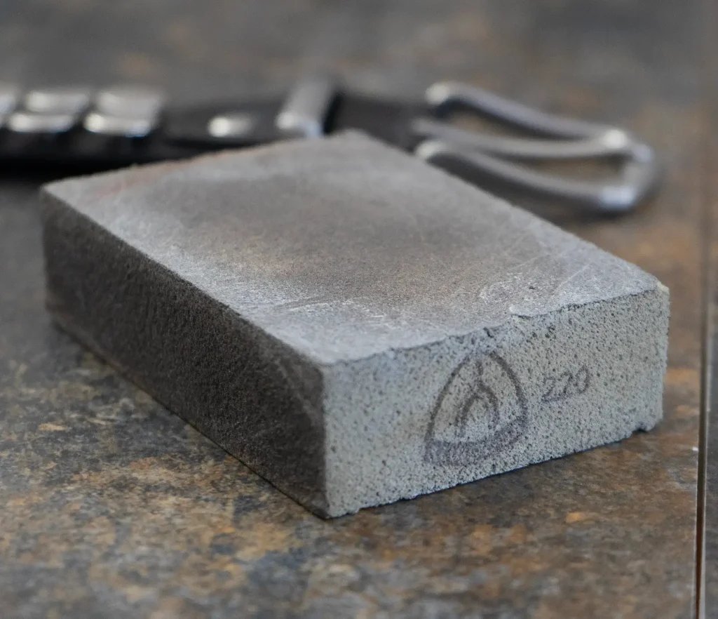 Sanding clutch for brushed rivets